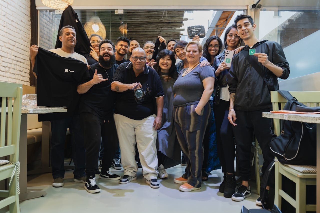 A diverse group of colleagues posing together, showcasing team spirit and camaraderie indoors.
